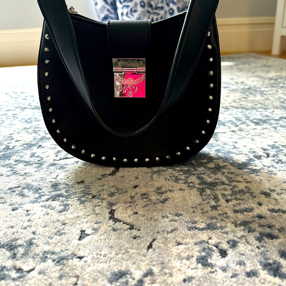 Never used MCM handbag with monogrammed MCM strap.